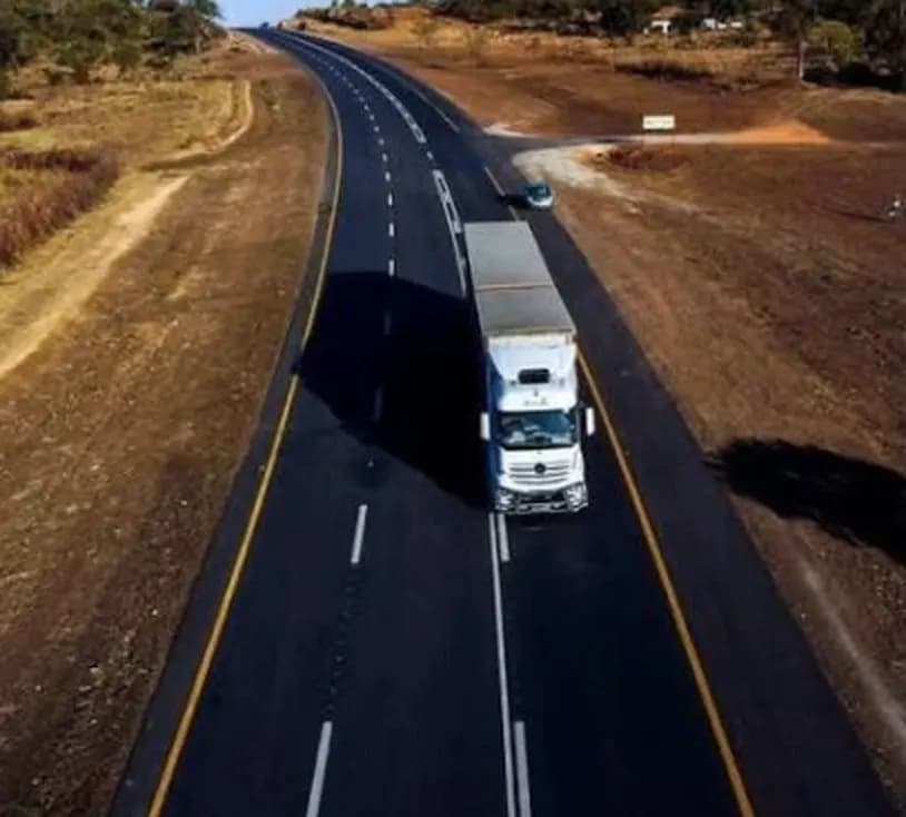 A rehabilitated dual-lane section of the Beitbridge–Harare–Chirundu highway, with a haulage truck travelling north.